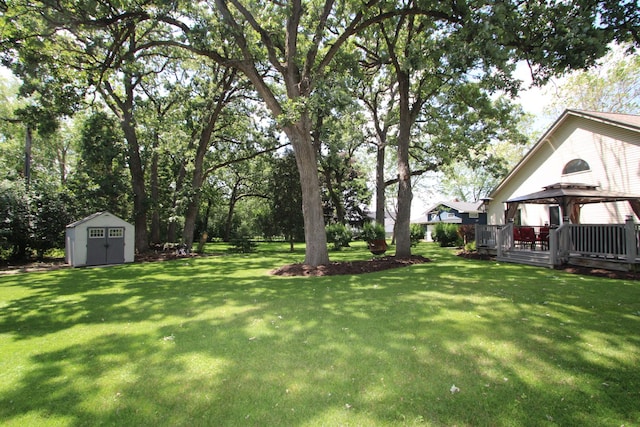 135 Miller Rd, Lake Zurich, IL 60047 - view of green lawn featuring a gazebo, a storage shed, and view of wooded area