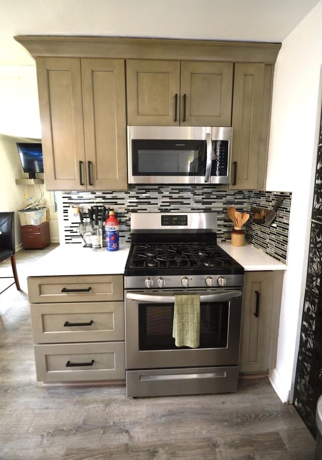 1509 Morris Ave, Berkeley, IL 60163 - kitchen featuring appliances with stainless steel finishes, light countertops, decorative backsplash, and dark wood-style flooring
