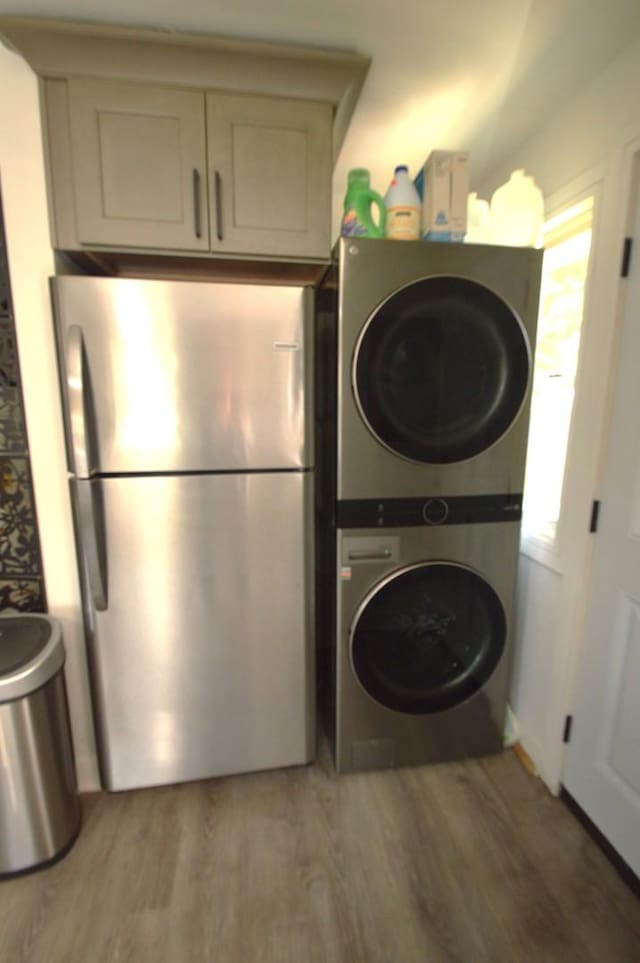 1509 Morris Ave, Berkeley, IL 60163 - laundry area with stacked washer / drying machine, light wood-type flooring, and cabinet space