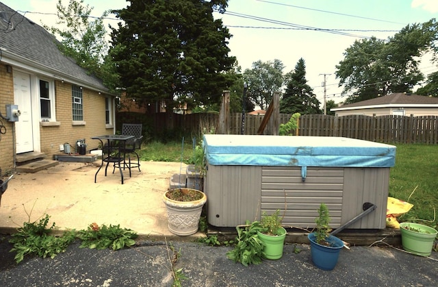 1509 Morris Ave, Berkeley, IL 60163 - fenced backyard featuring a hot tub, entry steps, and a patio area