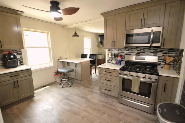 1509 Morris Ave, Berkeley, IL 60163 - kitchen with stainless steel appliances, decorative backsplash, a ceiling fan, and light wood-style flooring
