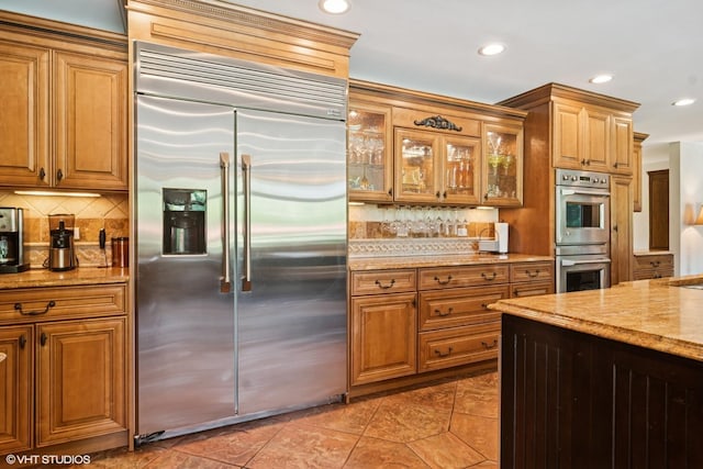 10305 Ridge Ln, Huntley, IL 60142 - kitchen with appliances with stainless steel finishes, decorative backsplash, light stone counters, and recessed lighting