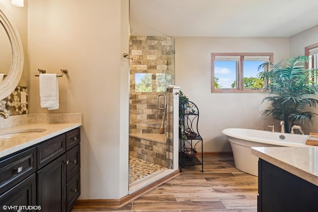 10305 Ridge Ln, Huntley, IL 60142 - full bath with vanity, a stall shower, a freestanding bath, and wood finished floors