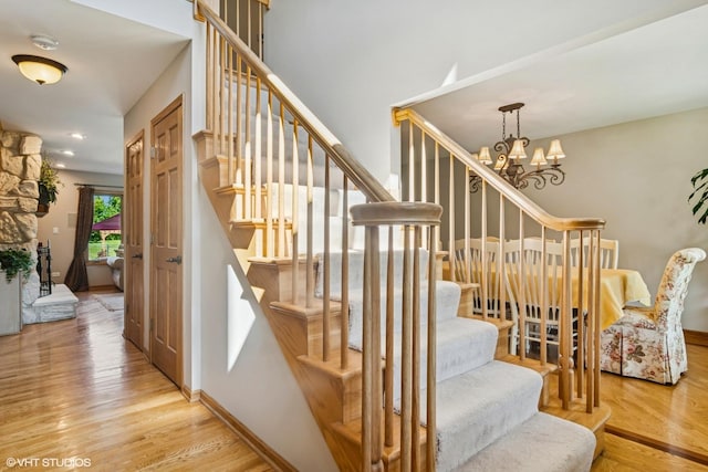 10305 Ridge Ln, Huntley, IL 60142 - staircase featuring wood finished floors and a chandelier
