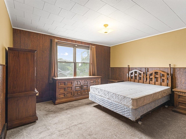 2242 S 5th St, Rockford, IL 61104 - carpeted bedroom featuring wooden walls, a wainscoted wall, and ornamental molding