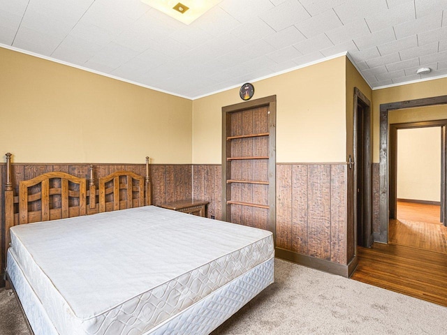 2242 S 5th St, Rockford, IL 61104 - carpeted bedroom with ornamental molding, wainscoting, and wooden walls
