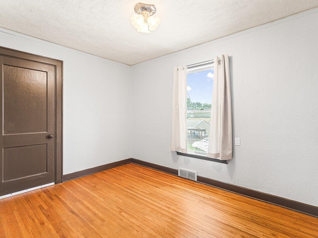 2242 S 5th St, Rockford, IL 61104 - empty room featuring light wood finished floors and a textured ceiling