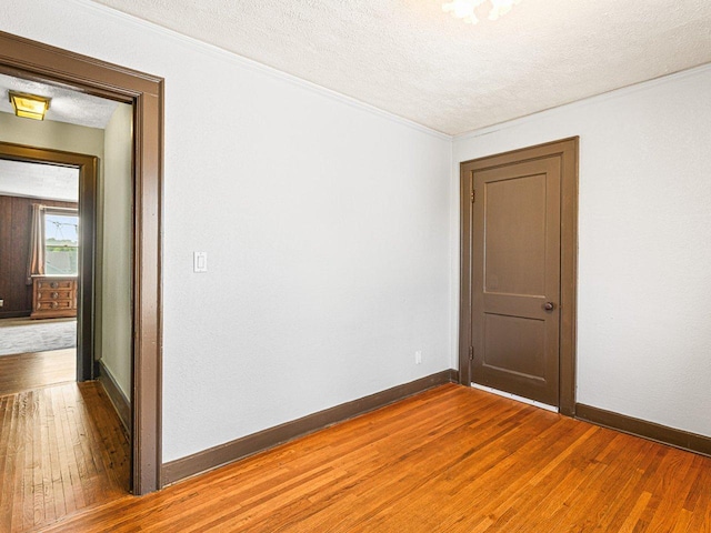 2242 S 5th St, Rockford, IL 61104 - unfurnished room featuring hardwood / wood-style floors, a textured ceiling, and crown molding
