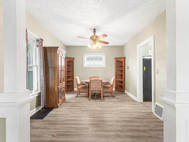 2242 S 5th St, Rockford, IL 61104 - dining space featuring wood finished floors, a ceiling fan, and a textured ceiling