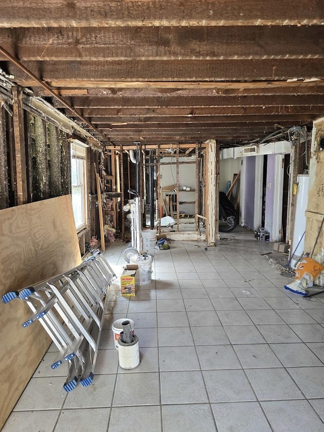 3447 W Melrose St, Chicago, IL 60618 - below grade area with water heater and tile patterned floors
