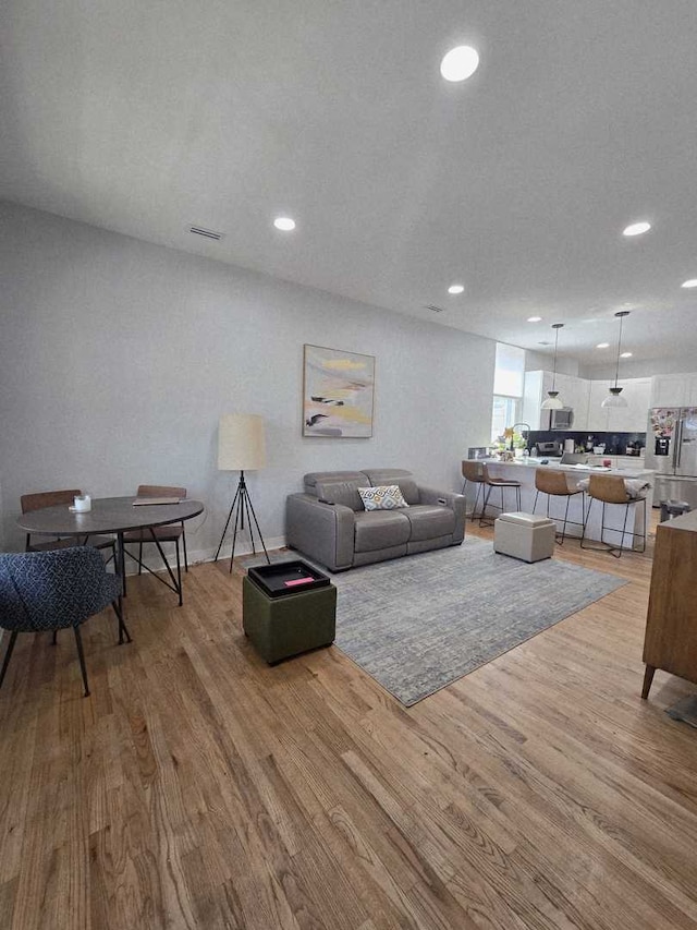 3447 W Melrose St, Chicago, IL 60618 - living room with light wood-style flooring and recessed lighting