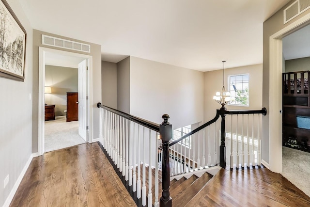 2301 Bluewater Dr, Wauconda, IL 60084 - hall featuring an upstairs landing, a chandelier, and wood finished floors
