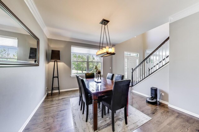 2301 Bluewater Dr, Wauconda, IL 60084 - dining room with stairway, wood finished floors, crown molding, and a chandelier