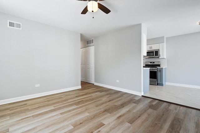 676 Cleo Ct Unit 676, Wheeling, IL 60090 - unfurnished living room featuring a ceiling fan and light wood-style flooring