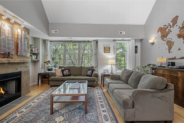 3251 N Racine Ave Unit 3, Chicago, IL 60657 - living area featuring a fireplace, light wood-style floors, plenty of natural light, and high vaulted ceiling