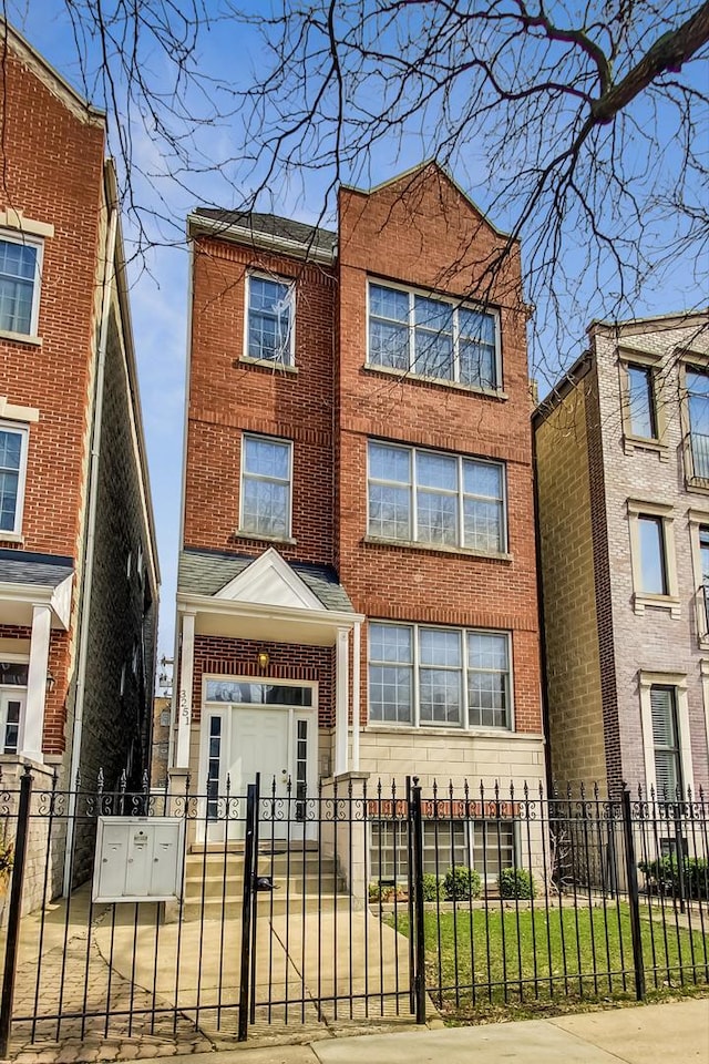 3251 N Racine Ave Unit 3, Chicago, IL 60657 - view of front of home featuring a fenced front yard, brick siding, and a gate