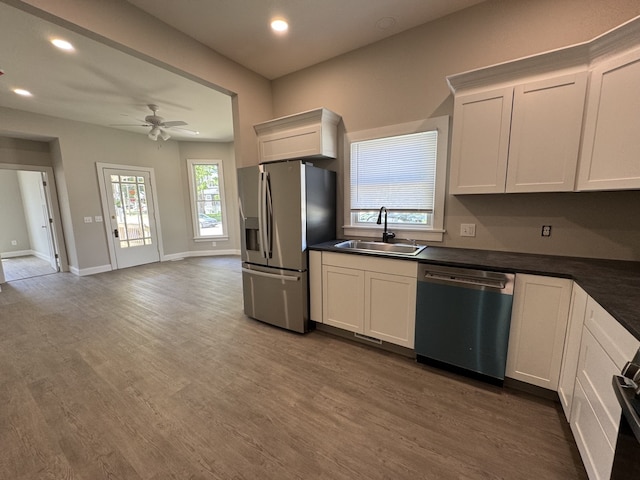 207 W Graham St, Bloomington, IL 61701 - kitchen featuring appliances with stainless steel finishes, dark countertops, recessed lighting, a ceiling fan, and wood finished floors