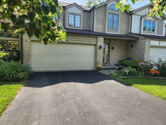 11031 S 84th Ave, Palos Hills, IL 60465 - view of front of property with an attached garage, brick siding, and driveway