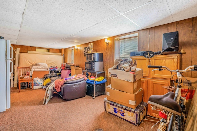 4438 N Moody Ave, Chicago, IL 60630 - basement with freestanding refrigerator, carpet flooring, wooden walls, and a paneled ceiling