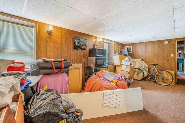 4438 N Moody Ave, Chicago, IL 60630 - living room featuring carpet, wooden walls, and a paneled ceiling