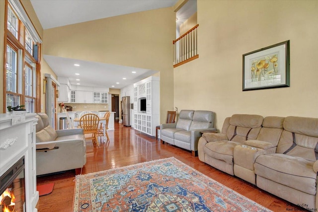 1505 Della Dr, Hoffman Estates, IL 60169 - living room with a warm lit fireplace, high vaulted ceiling, and wood finished floors