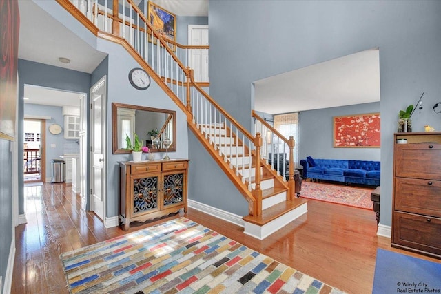 1505 Della Dr, Hoffman Estates, IL 60169 - staircase featuring wood finished floors and a high ceiling