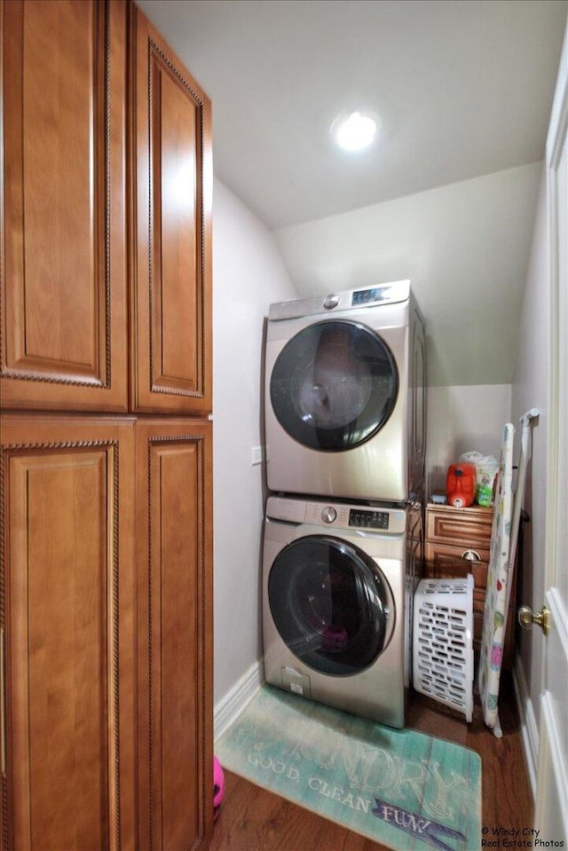 1505 Della Dr, Hoffman Estates, IL 60169 - laundry room featuring stacked washing machine and dryer, wood finished floors, and cabinet space