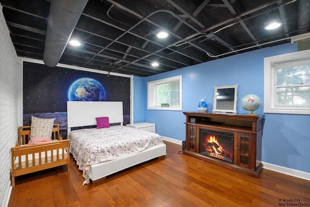 1505 Della Dr, Hoffman Estates, IL 60169 - bedroom with wood finished floors and a warm lit fireplace