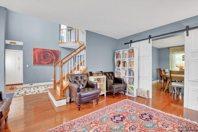 1505 Della Dr, Hoffman Estates, IL 60169 - sitting room featuring a barn door, wood finished floors, and stairway