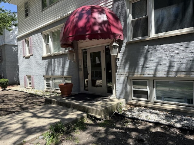 9513 Kelvin Ln Unit 2111, Schiller Park, IL 60176 - view of exterior entry featuring brick siding