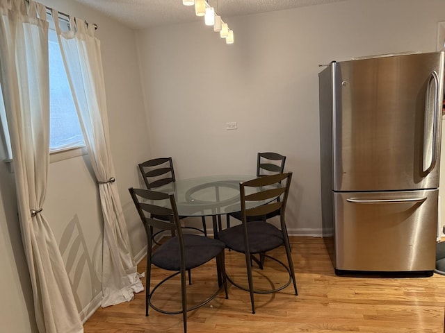 9513 Kelvin Ln Unit 2111, Schiller Park, IL 60176 - dining area with light wood-type flooring and a textured ceiling
