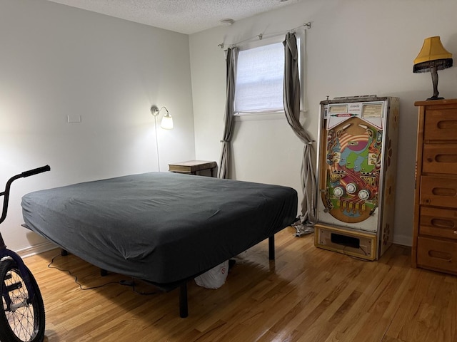 9513 Kelvin Ln Unit 2111, Schiller Park, IL 60176 - bedroom featuring a textured ceiling and light wood-style floors