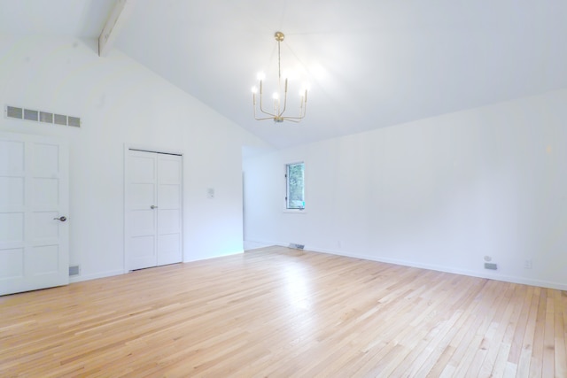 921 Cassie Dr, Joliet, IL 60435 - unfurnished living room with a chandelier, light wood-style flooring, beamed ceiling, and high vaulted ceiling