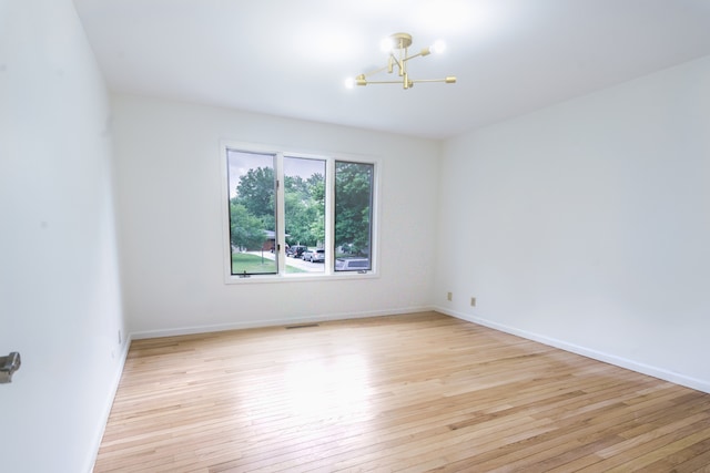921 Cassie Dr, Joliet, IL 60435 - unfurnished room featuring a chandelier and light wood finished floors