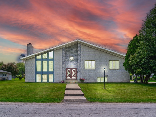 921 Cassie Dr, Joliet, IL 60435 - mid-century modern home with a chimney, brick siding, and a front yard