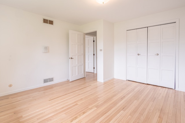 921 Cassie Dr, Joliet, IL 60435 - unfurnished bedroom featuring light wood finished floors and a closet