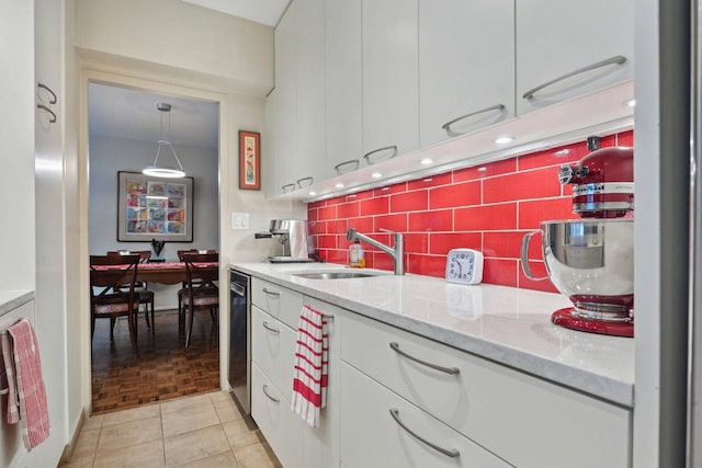 1325 N State Pkwy Unit 8E, Chicago, IL 60610 - kitchen with white cabinetry, backsplash, light stone counters, and stainless steel dishwasher