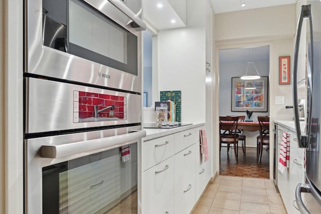 1325 N State Pkwy Unit 8E, Chicago, IL 60610 - kitchen featuring modern cabinets, light countertops, light tile patterned flooring, white cabinets, and recessed lighting