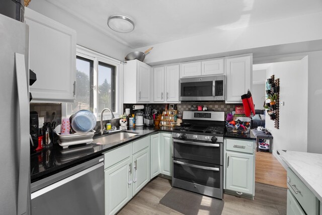 1100 Singleton Dr, Roselle, IL 60172 - kitchen with appliances with stainless steel finishes, decorative backsplash, light wood-type flooring, and white cabinets