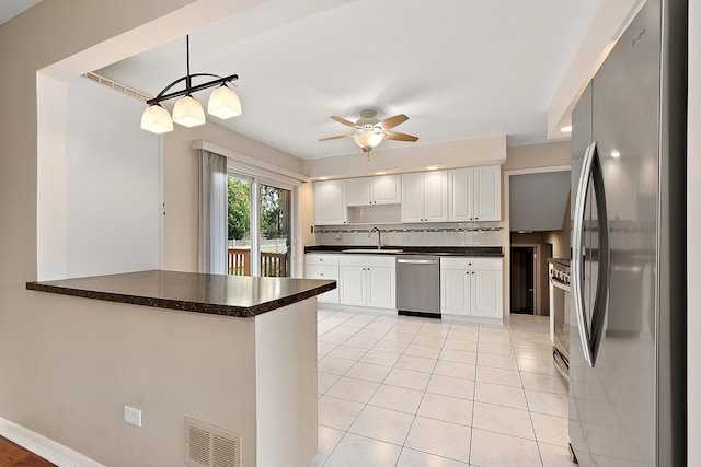 15363 Sunflower Ct, Orland Park, IL 60462 - kitchen featuring appliances with stainless steel finishes, dark countertops, ceiling fan, white cabinets, and light tile patterned floors