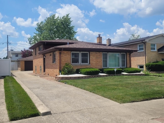 16030 Gauger Ave, Harvey, IL 60426 - split level home featuring brick siding, a chimney, a front lawn, a detached garage, and roof with shingles