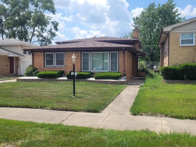 16030 Gauger Ave, Harvey, IL 60426 - view of front of property with brick siding, a chimney, and a front yard