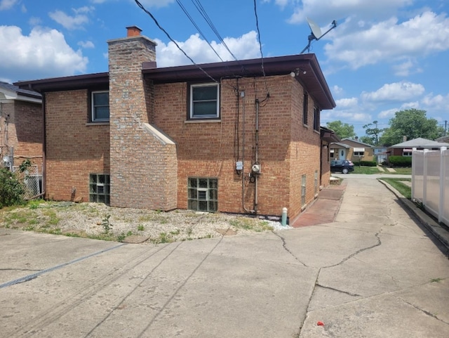 16030 Gauger Ave, Harvey, IL 60426 - rear view of house with a chimney and brick siding