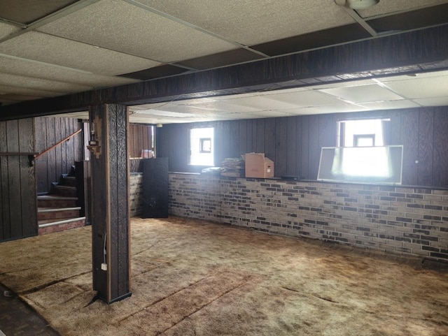 16030 Gauger Ave, Harvey, IL 60426 - basement with carpet floors, stairway, wooden walls, a drop ceiling, and brick wall