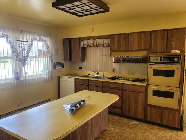 16030 Gauger Ave, Harvey, IL 60426 - kitchen featuring white appliances, light countertops, ventilation hood, tasteful backsplash, and a center island