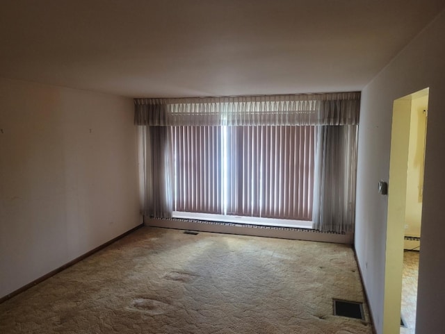 16030 Gauger Ave, Harvey, IL 60426 - unfurnished room with carpet flooring, healthy amount of natural light, and a baseboard radiator