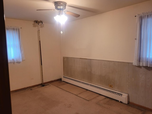 16030 Gauger Ave, Harvey, IL 60426 - carpeted empty room featuring a baseboard heating unit and ceiling fan