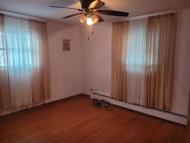16030 Gauger Ave, Harvey, IL 60426 - unfurnished room with a baseboard heating unit, wood finished floors, and a ceiling fan