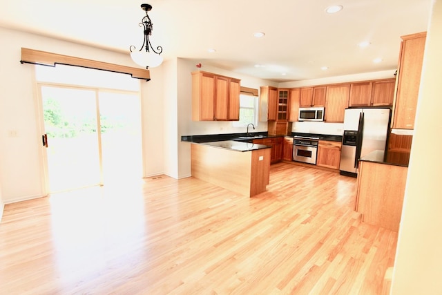 18737 W Ash Dr, Lake Villa, IL 60046 - kitchen with stainless steel appliances, a peninsula, dark countertops, light wood finished floors, and glass insert cabinets