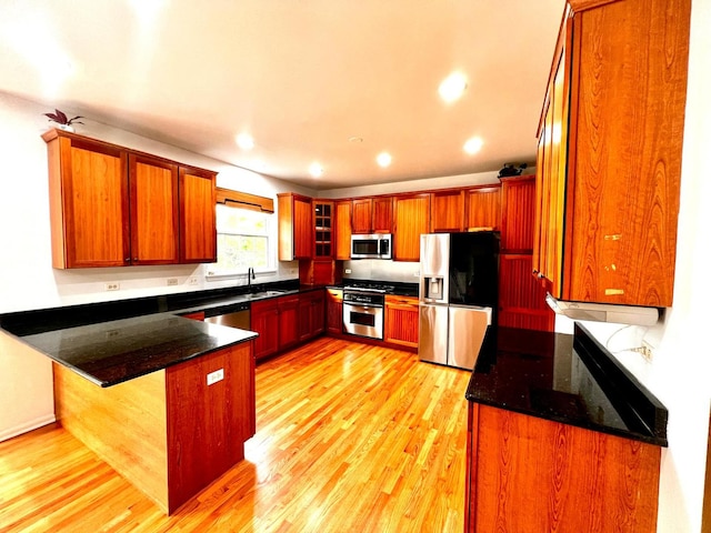 18737 W Ash Dr, Lake Villa, IL 60046 - kitchen featuring stainless steel appliances, a peninsula, light wood finished floors, dark stone countertops, and recessed lighting